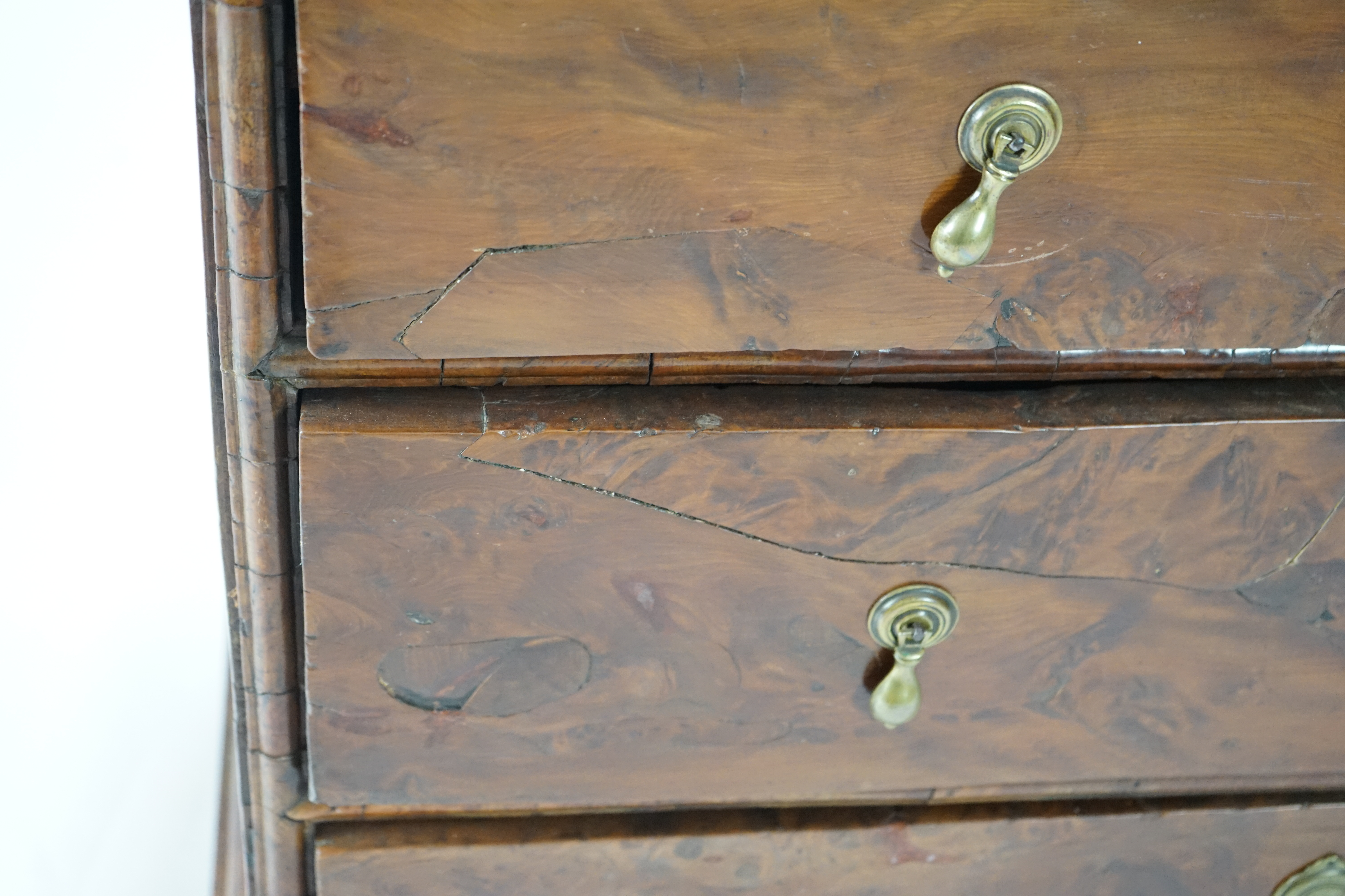 An early 18th century and later yew wood veneered oak chest